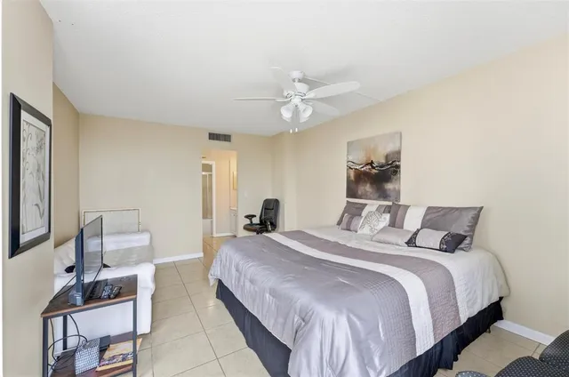 a bedroom with a bed and a chair