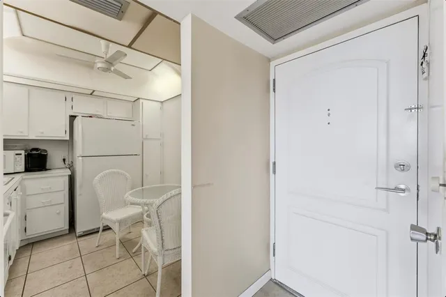 a utility room with cabinets and washer