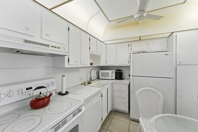 a utility room with sink dryer and washer