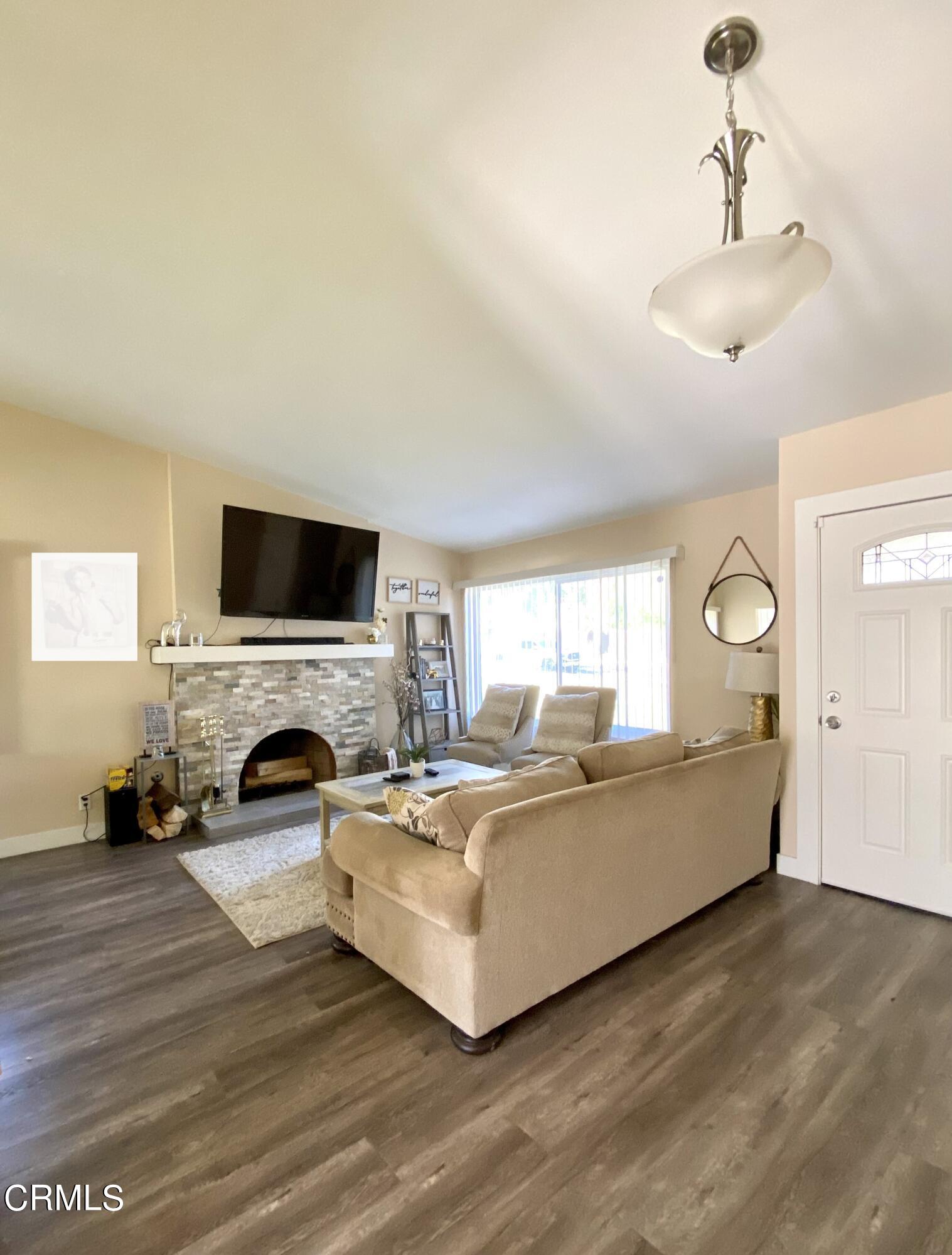 6260 45th Street Riverside, CA 92509 - Photo 3 of 18 a living room with furniture a fireplace and a flat screen tv