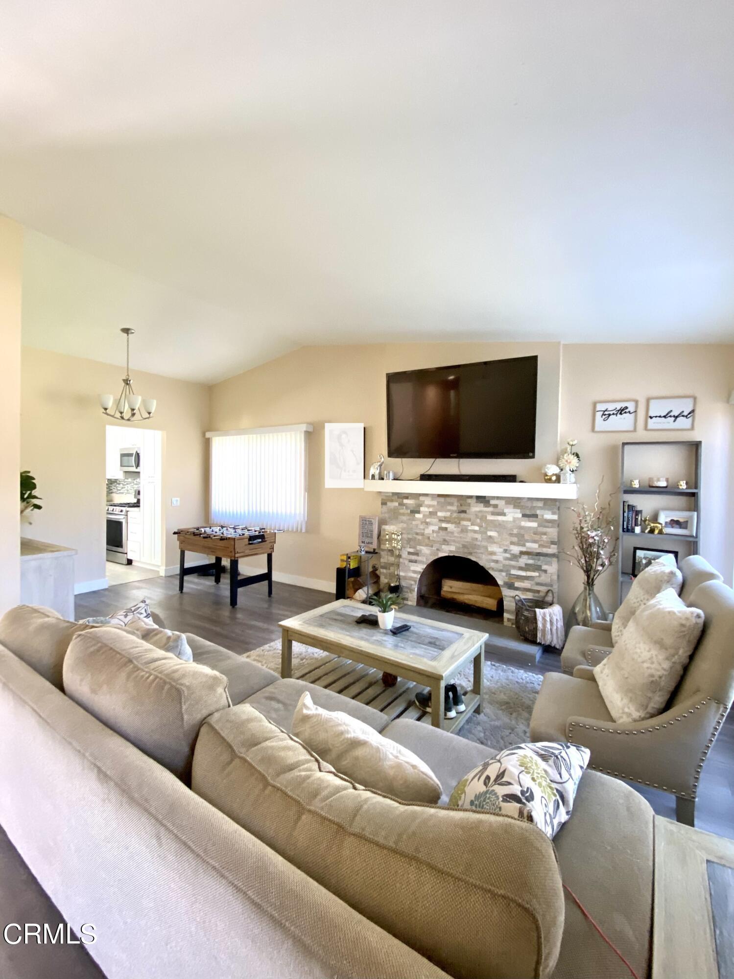 6260 45th Street Riverside, CA 92509 - Photo 4 of 18 a living room with furniture a fireplace and a flat screen tv