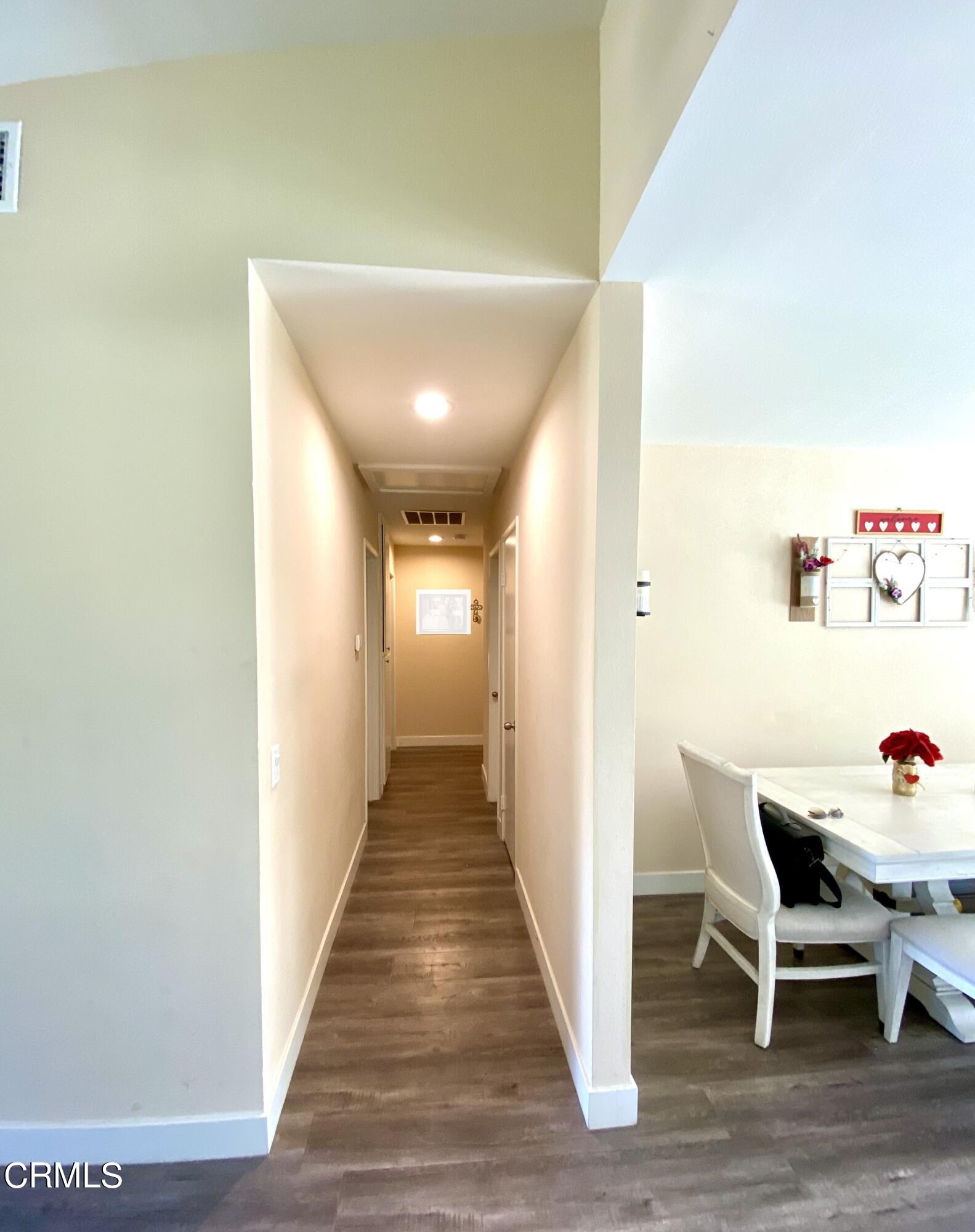 6260 45th Street Riverside, CA 92509 - Photo 10 of 18 a view of a hallway with wooden floor and furniture