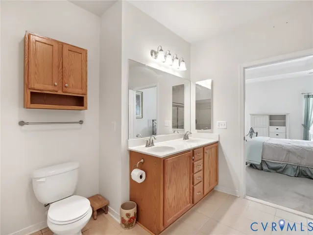 a spacious bathroom with a toilet sink and mirror