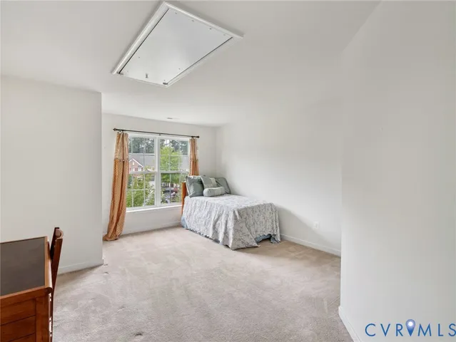 a spacious bedroom with a bed and a window