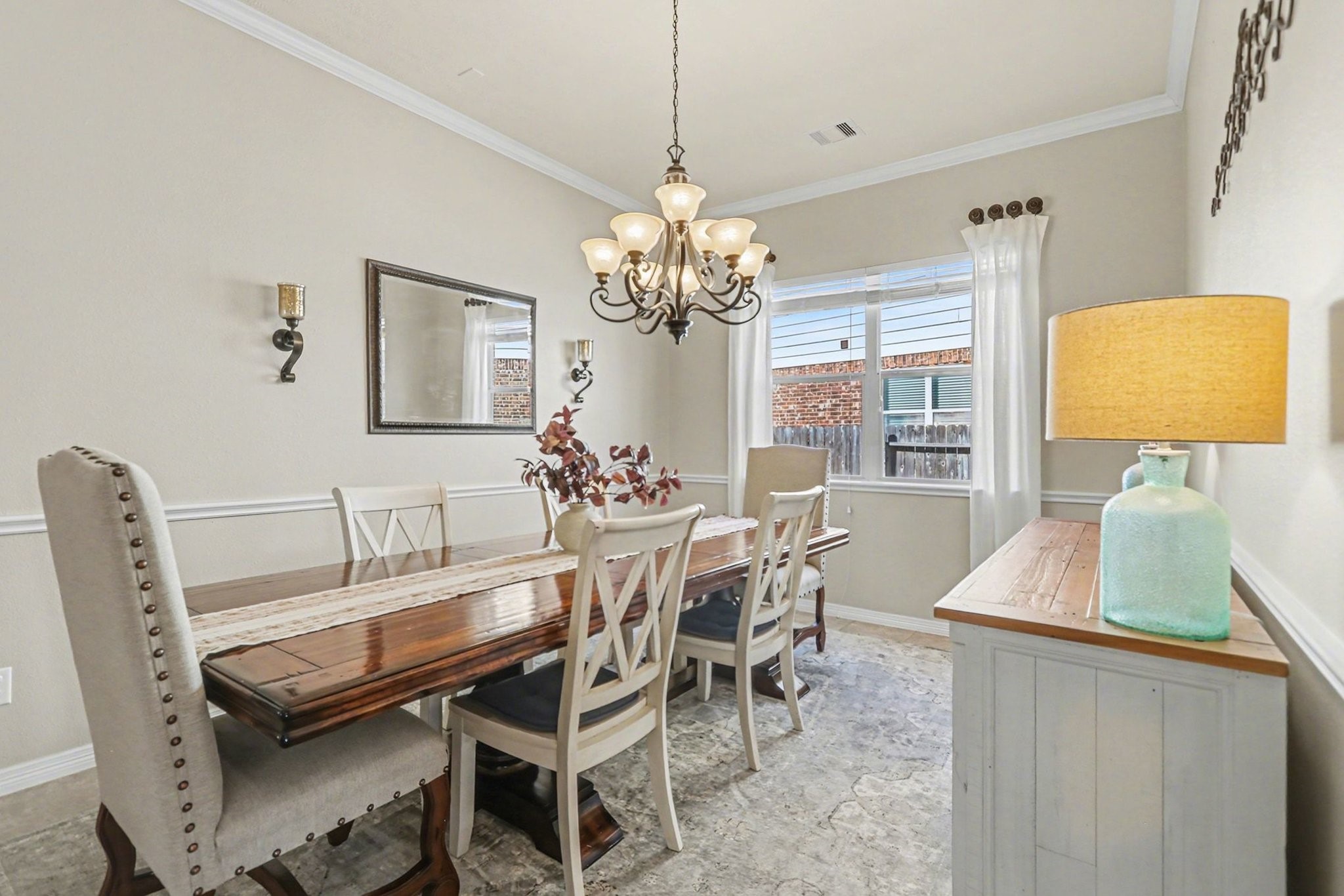 27006 Cliff Pointe Lane Katy, TX 77494 - Photo 9 of 34 An elegant formal dining room with crown molding and statement chandelier—perfect for hosting holidays, dinner parties, or intimate gatherings.