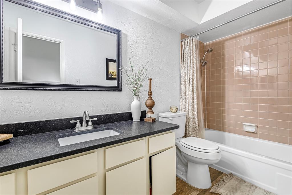 3740 Vitruvian Way, Unit D Addison, TX 75001 - Photo 14 of 22 a bathroom with a granite countertop sink a toilet a mirror and shower