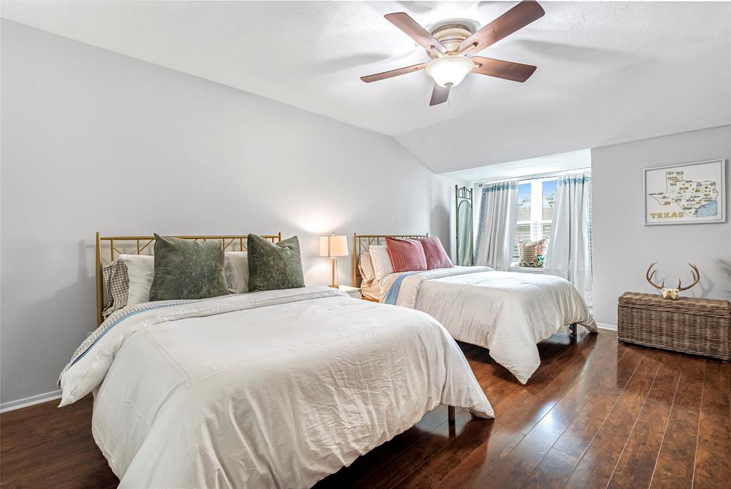 3740 Vitruvian Way, Unit D Addison, TX 75001 - Photo 15 of 22 a bedroom with two beds and a chandelier