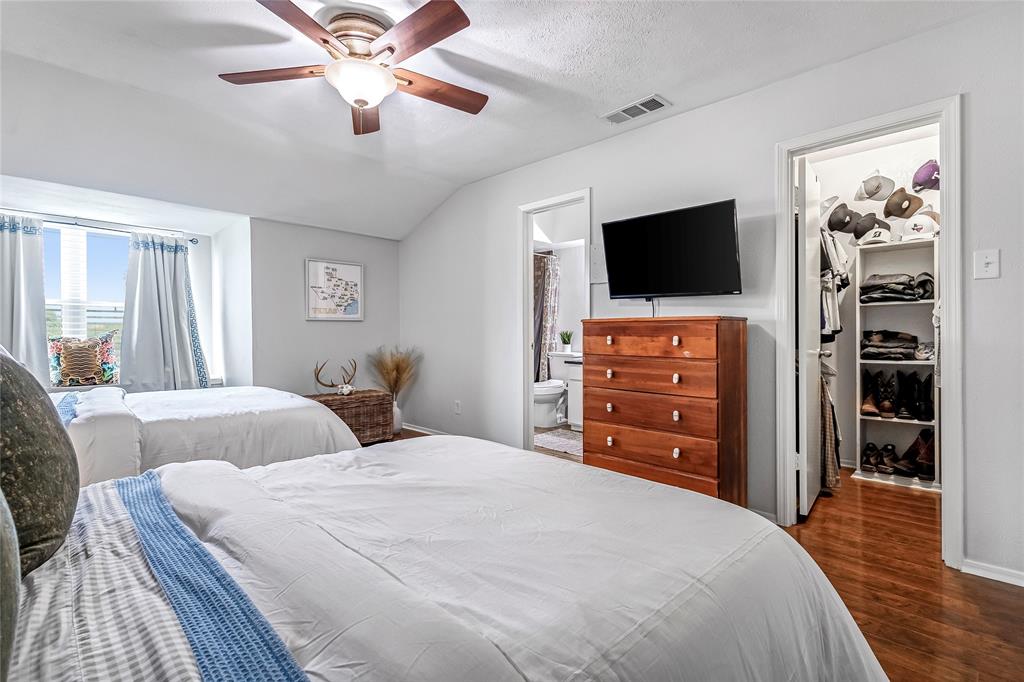 3740 Vitruvian Way, Unit D Addison, TX 75001 - Photo 16 of 22 a bedroom with a bed and a flat screen tv