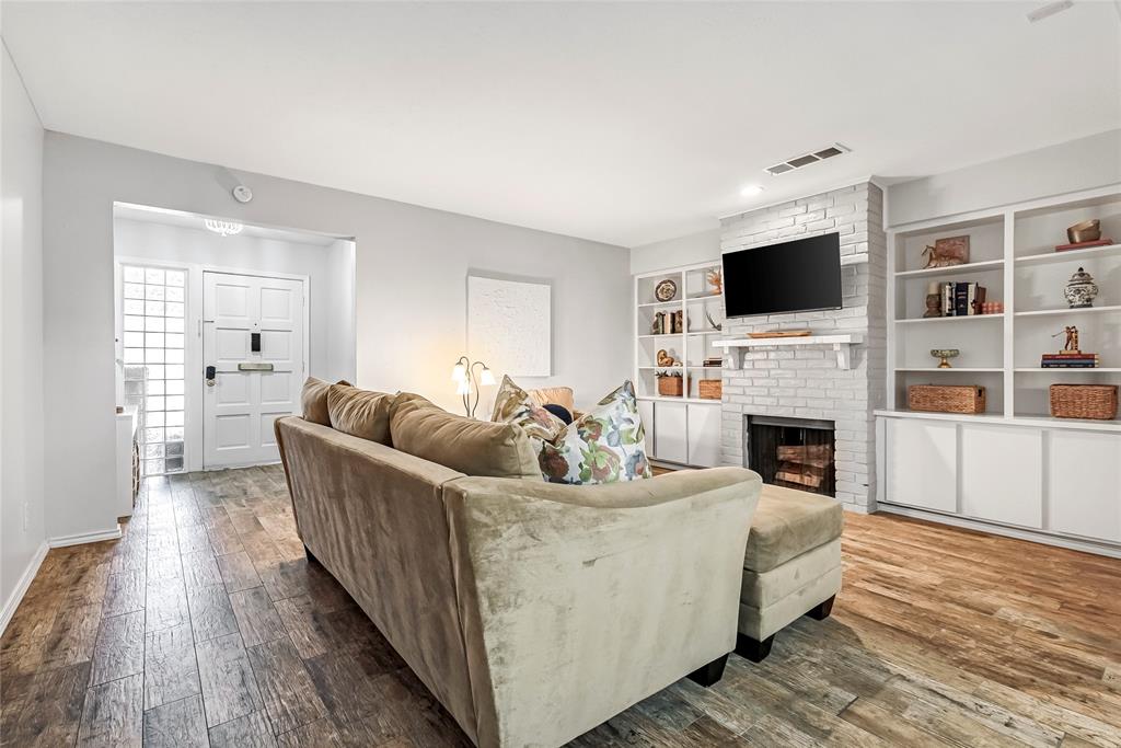 3740 Vitruvian Way, Unit D Addison, TX 75001 - Photo 3 of 22 a living room with furniture a flat screen tv and a fireplace