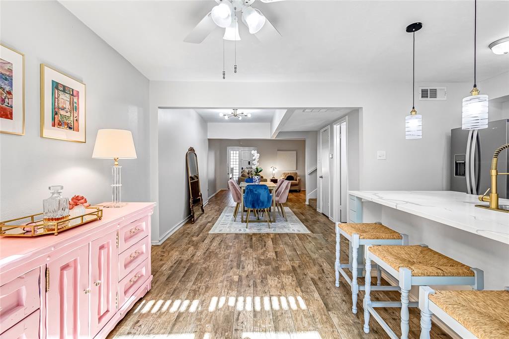 3740 Vitruvian Way, Unit D Addison, TX 75001 - Photo 9 of 22 a very nice looking dining room with a large bed a chandelier and kitchen view