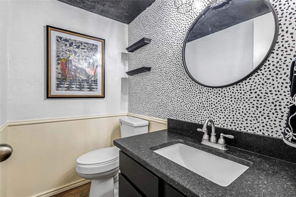 3740 Vitruvian Way, Unit D Addison, TX 75001 - Photo 10 of 22 a bathroom with a granite countertop toilet a sink and a mirror