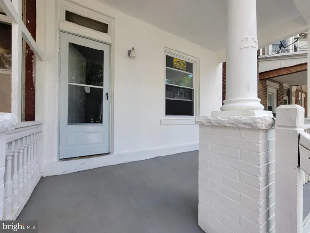 a view of a hallway with windows and cabinet