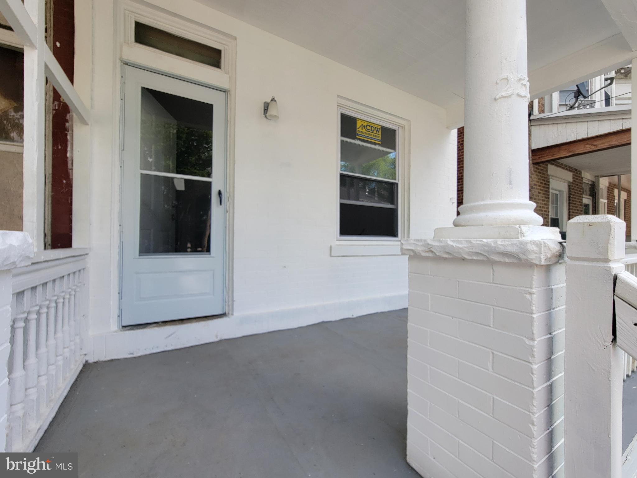 a view of a hallway with windows and cabinet
