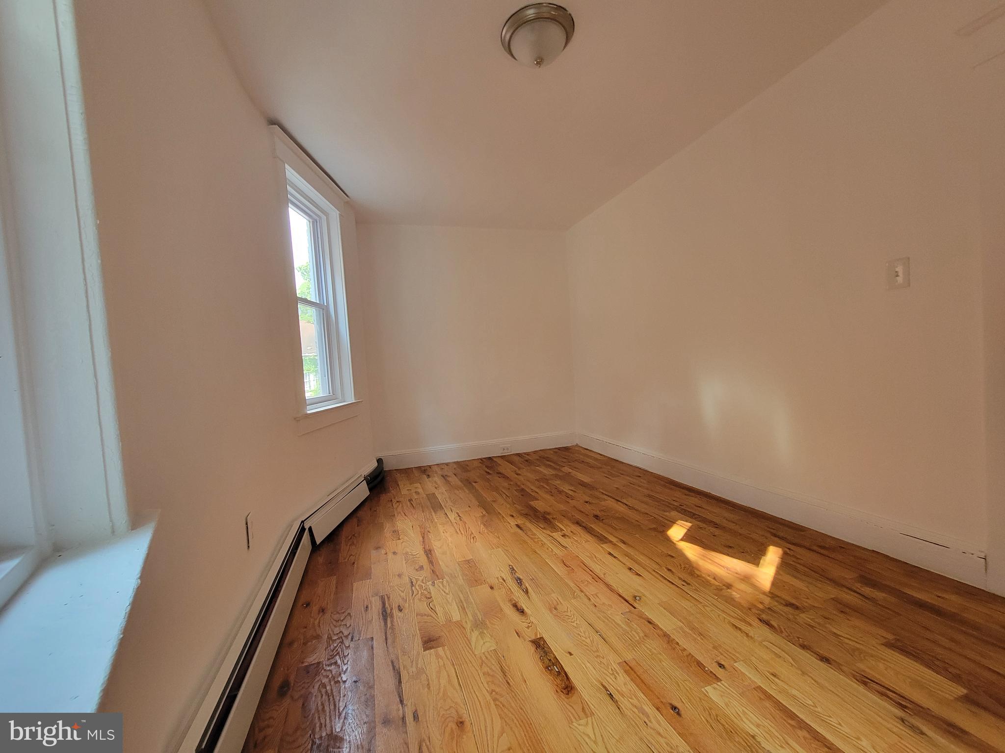 238 Rosemont Avenue Trenton, NJ 08618 - Photo 2 of 9 a view of empty room with wooden floor and fan