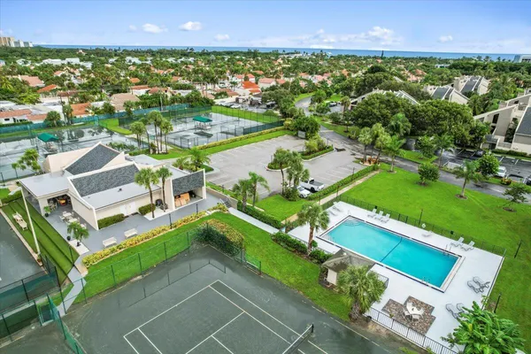 an aerial view of residential houses with outdoor space and street view