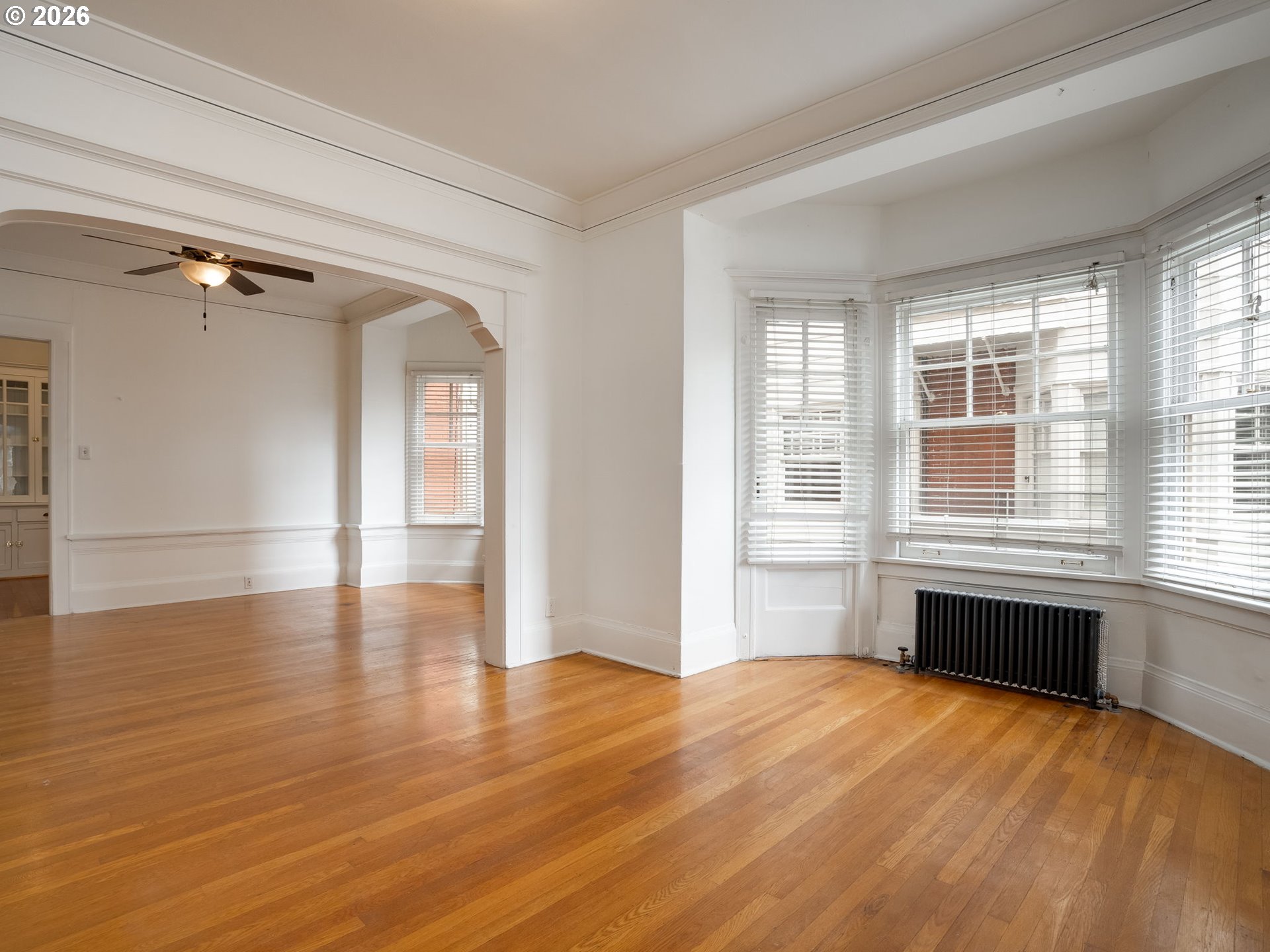 2083 Northwest Johnson Street, Unit 41 Portland, OR 97209 - Photo 12 of 25 a view of an empty room with a window and wooden floor