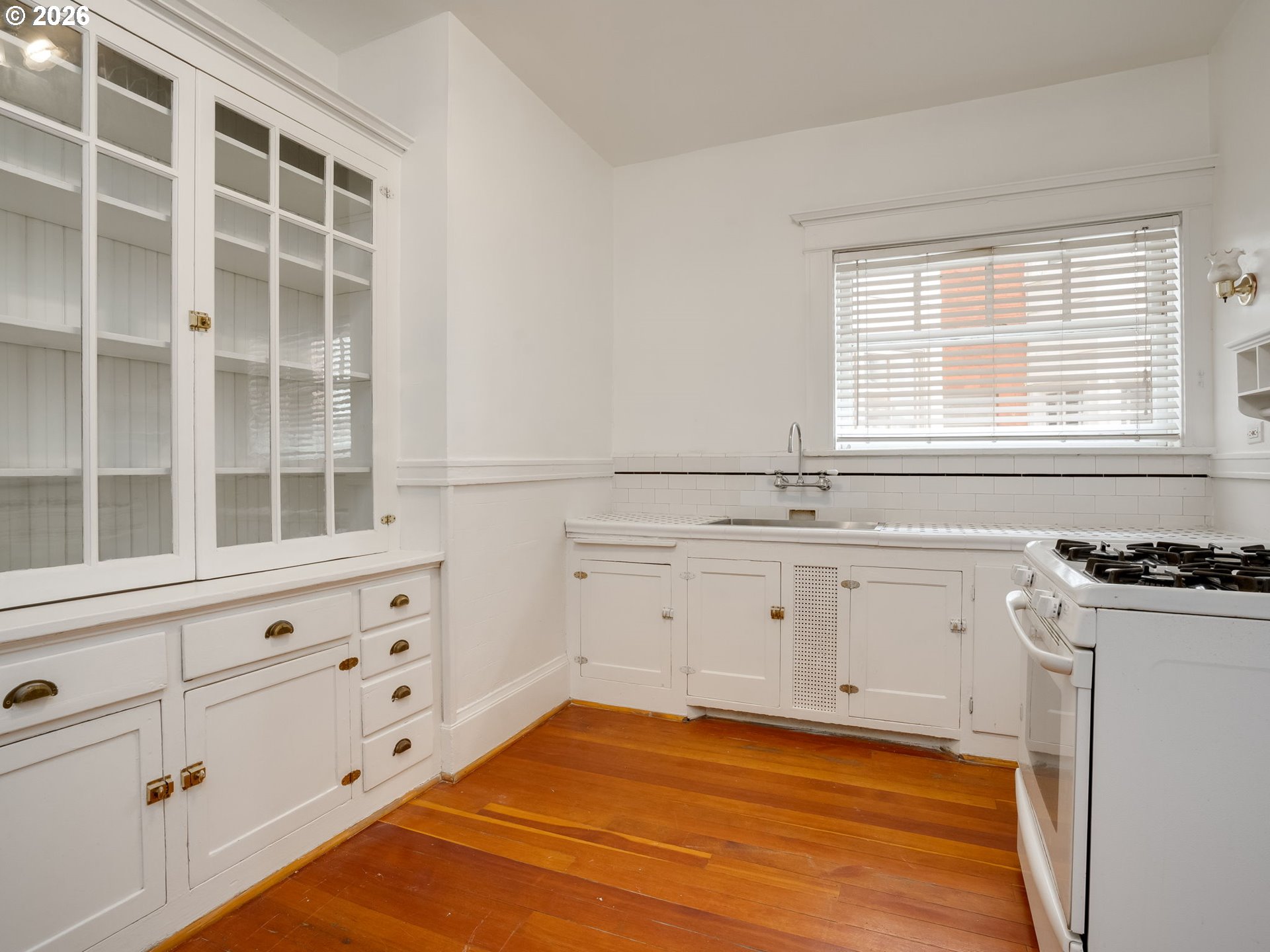2083 Northwest Johnson Street, Unit 41 Portland, OR 97209 - Photo 15 of 25 a kitchen with granite countertop white cabinets and window