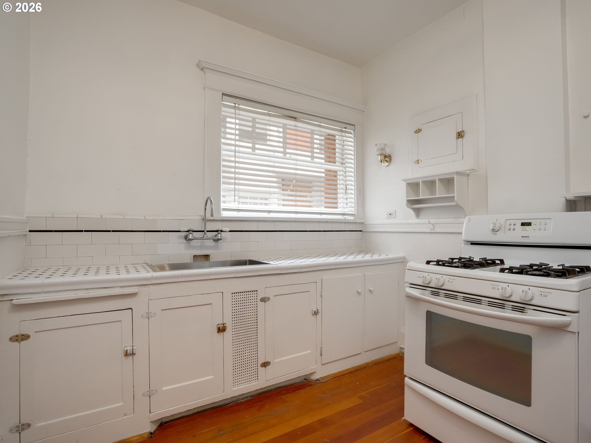 2083 Northwest Johnson Street, Unit 41 Portland, OR 97209 - Photo 16 of 25 a kitchen with white cabinets stainless steel appliances and sink