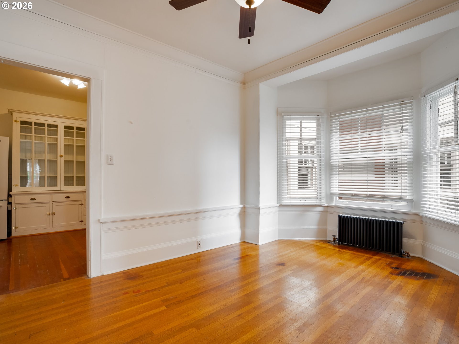 2083 Northwest Johnson Street, Unit 41 Portland, OR 97209 - Photo 24 of 25 an empty room with wooden floor and windows
