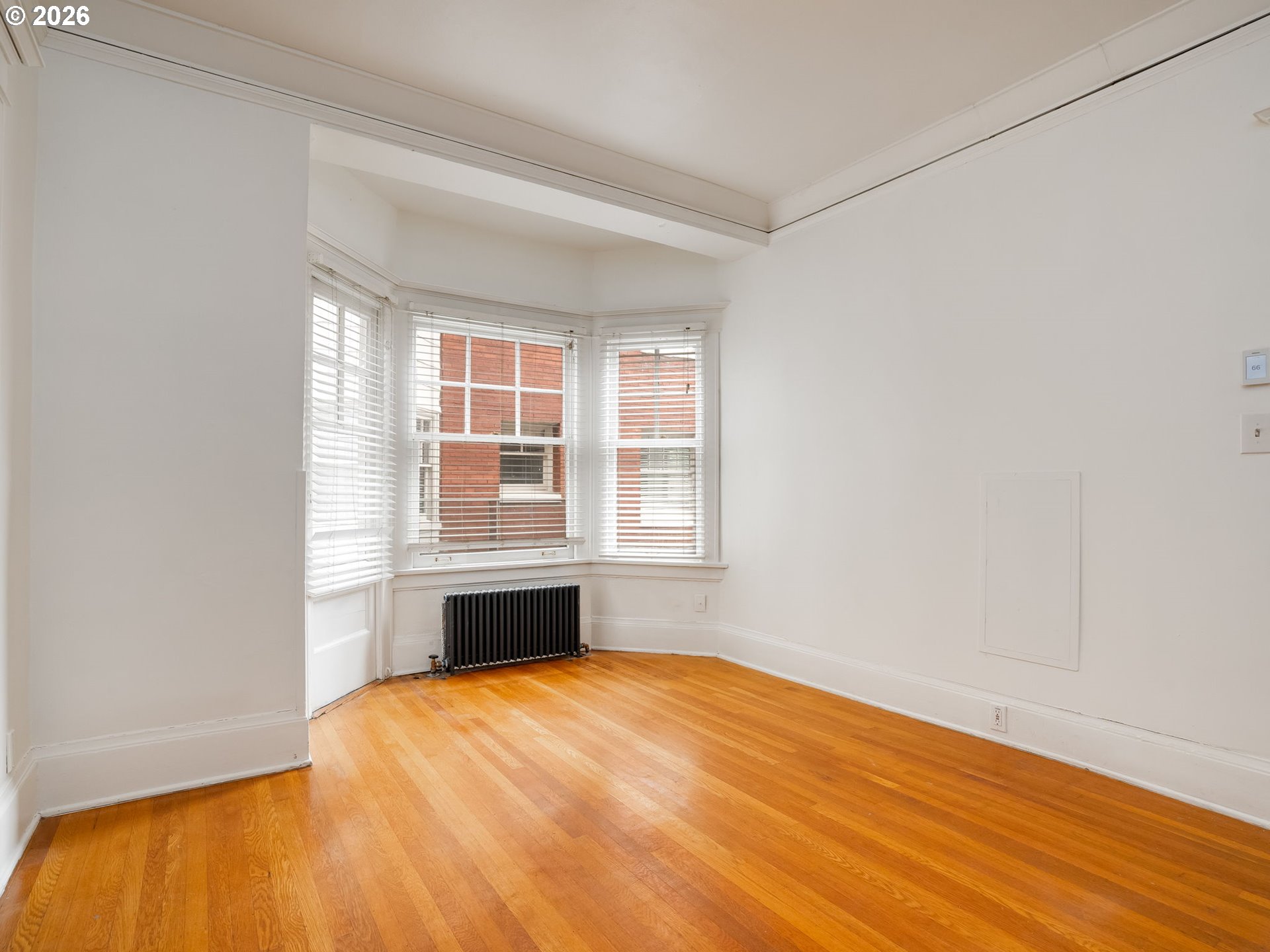 2083 Northwest Johnson Street, Unit 41 Portland, OR 97209 - Photo 10 of 25 a view of an empty room with wooden floor and a window