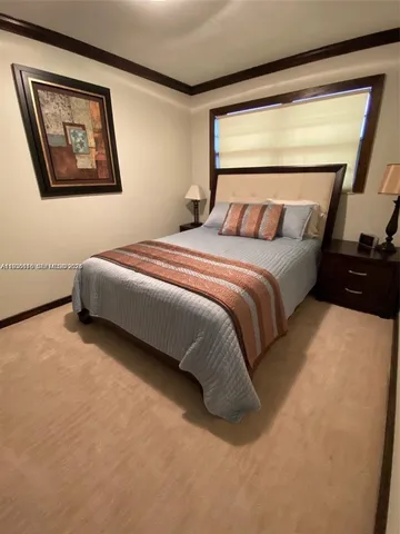 a bedroom with a bed next to a window