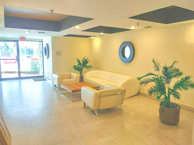 a living room with couches and a potted plant