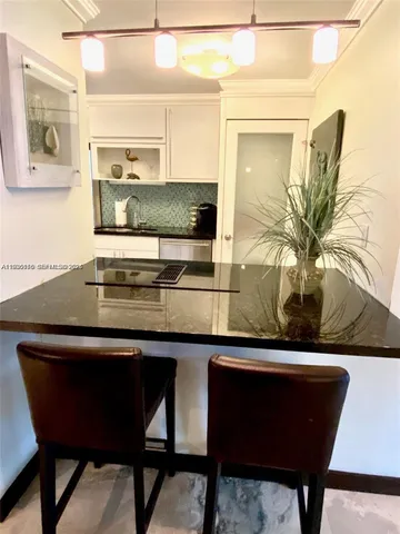 a kitchen with a table and chairs in it