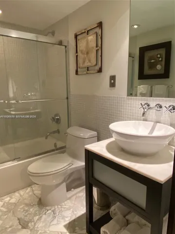 a bathroom with a sink toilet and a mirror