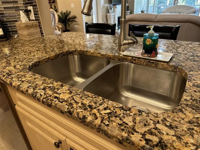 a kitchen with stainless steel appliances granite countertop a sink stove and cabinets