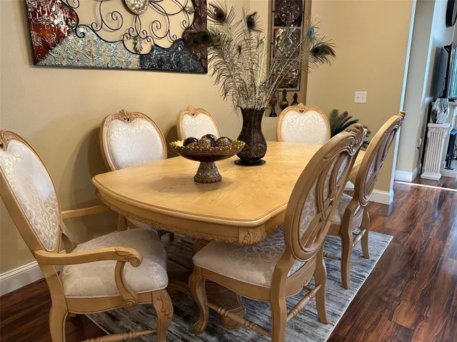 a living room with furniture dining table and a flat screen tv