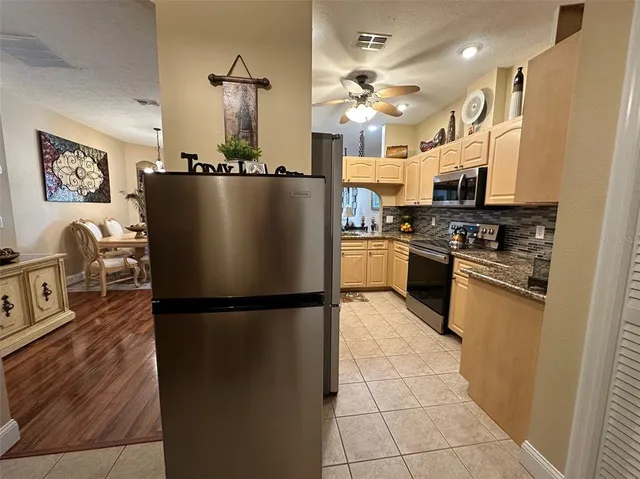 a kitchen with stainless steel appliances granite countertop a stove a sink and a microwave