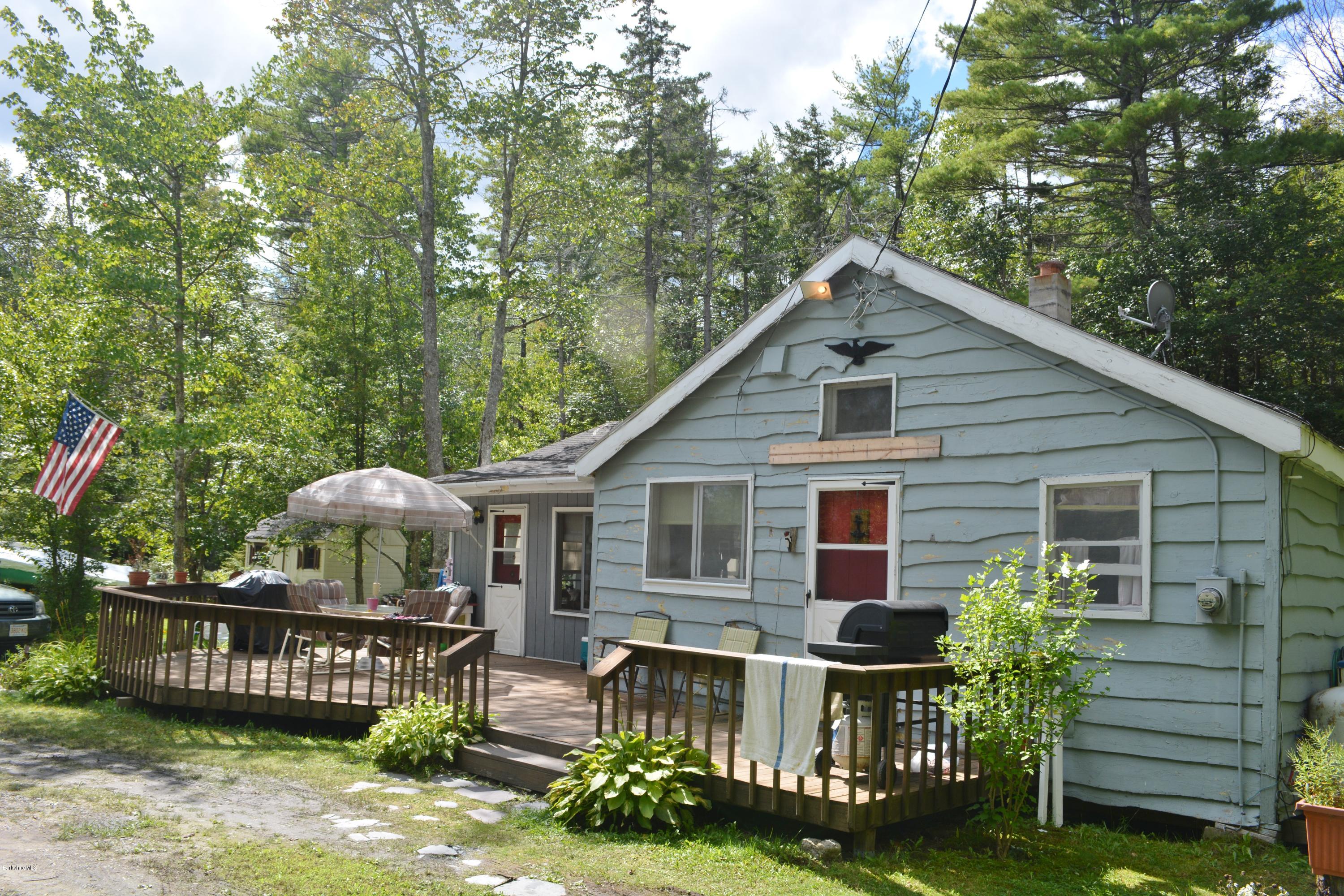 537 Lion Hill Road Otis, MA 01029 - Photo 3 of 6 a front view of a house with garden and patio