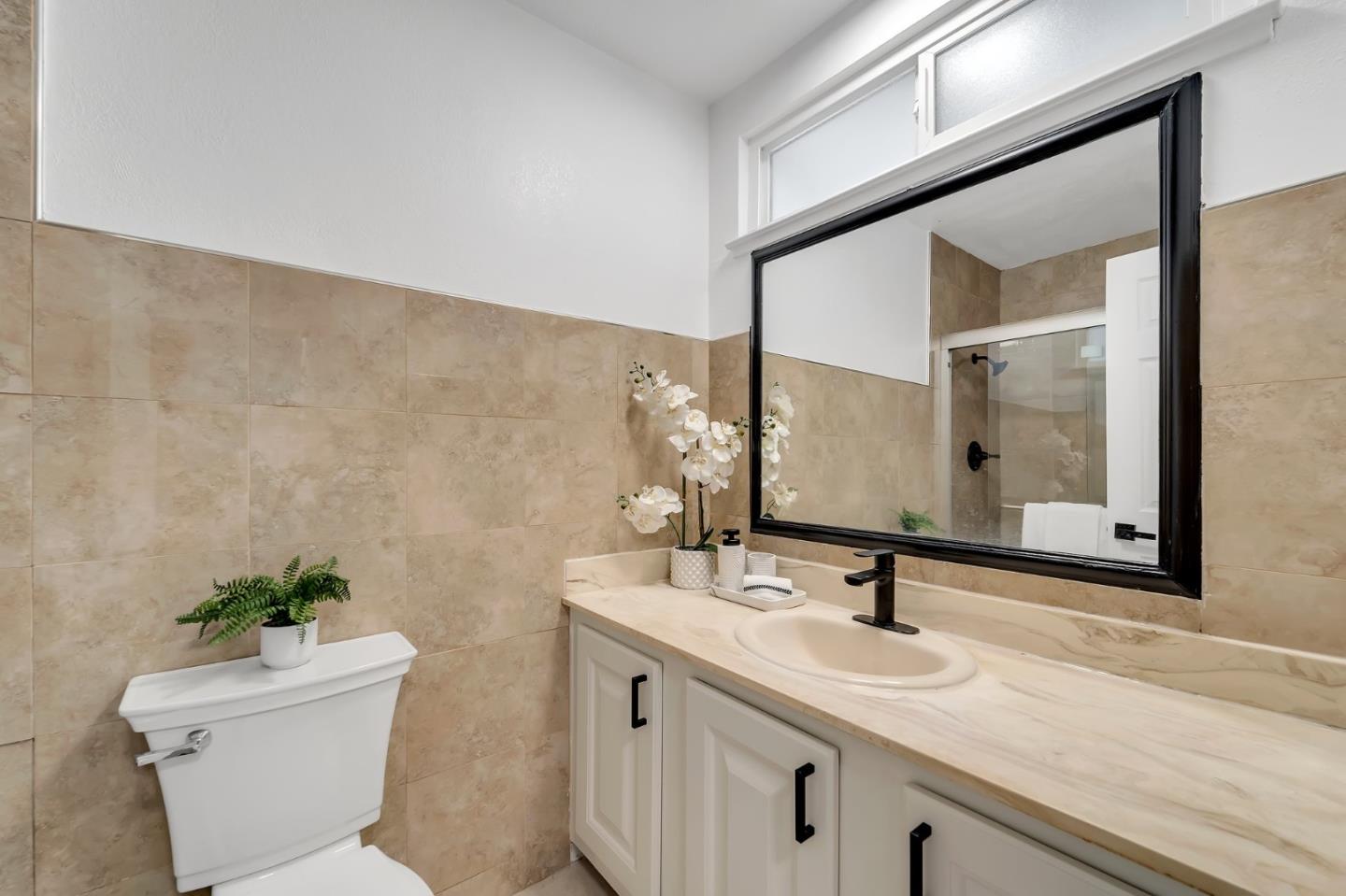4824 Poston Drive San Jose, CA 95136 - Photo 16 of 33 a bathroom with a granite countertop sink and a mirror