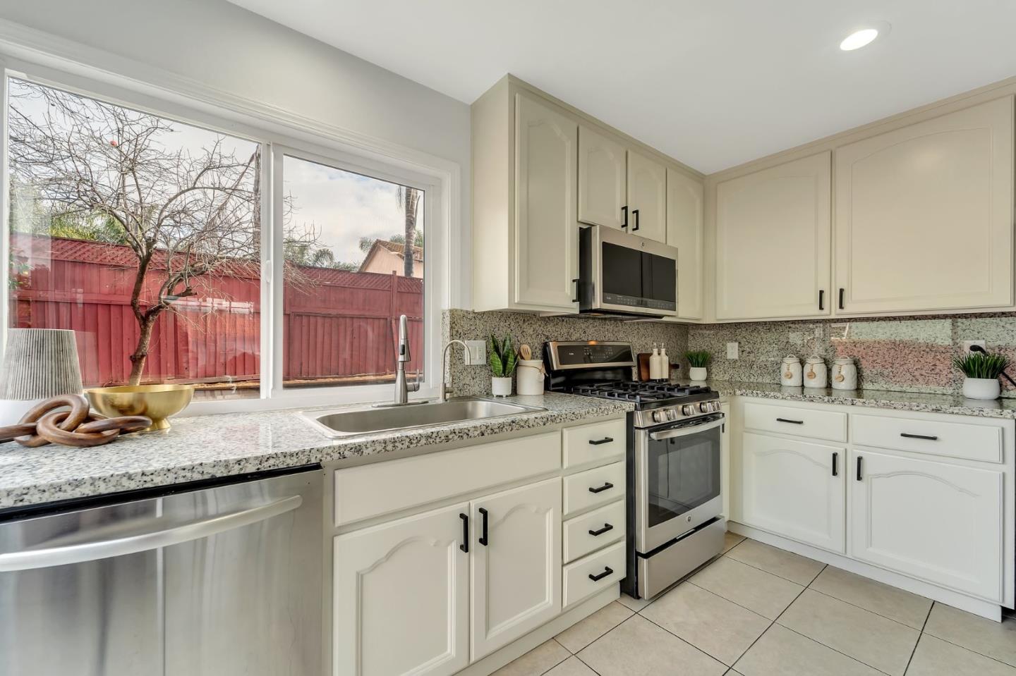 4824 Poston Drive San Jose, CA 95136 - Photo 8 of 33 a kitchen with granite countertop a sink stove and cabinets