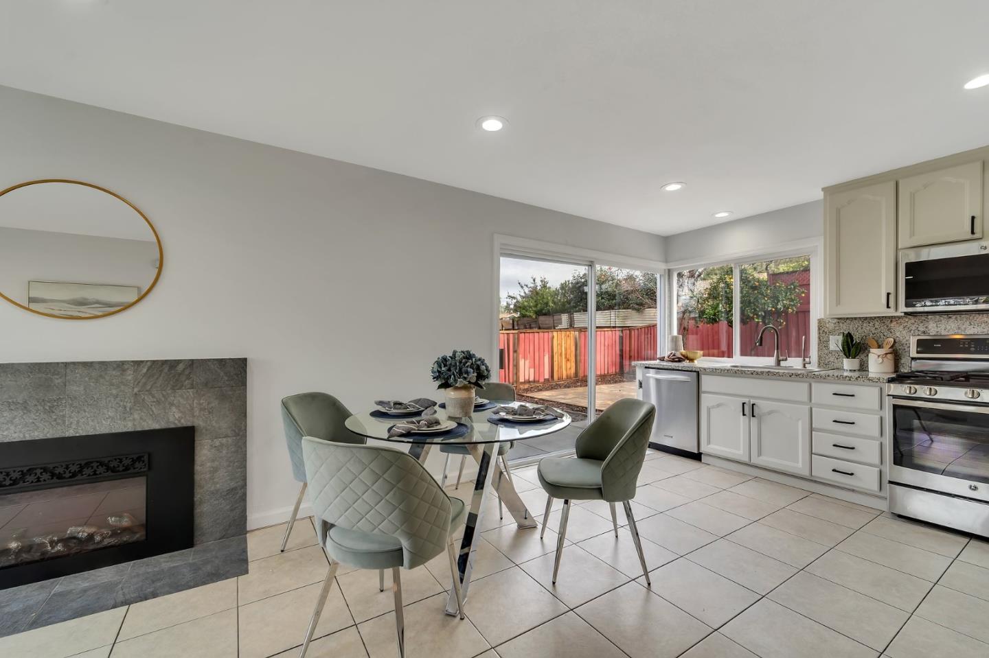 4824 Poston Drive San Jose, CA 95136 - Photo 10 of 33 a kitchen with microwave a stove a dining table and chairs