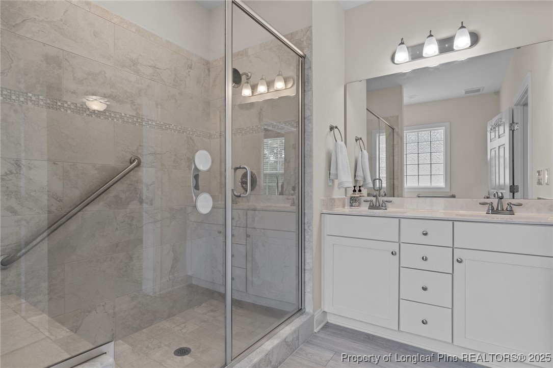 288 Gallery Drive, Unit 204 Spring Lake, NC 28390 - Photo 17 of 27 a bathroom with a shower sink and mirror