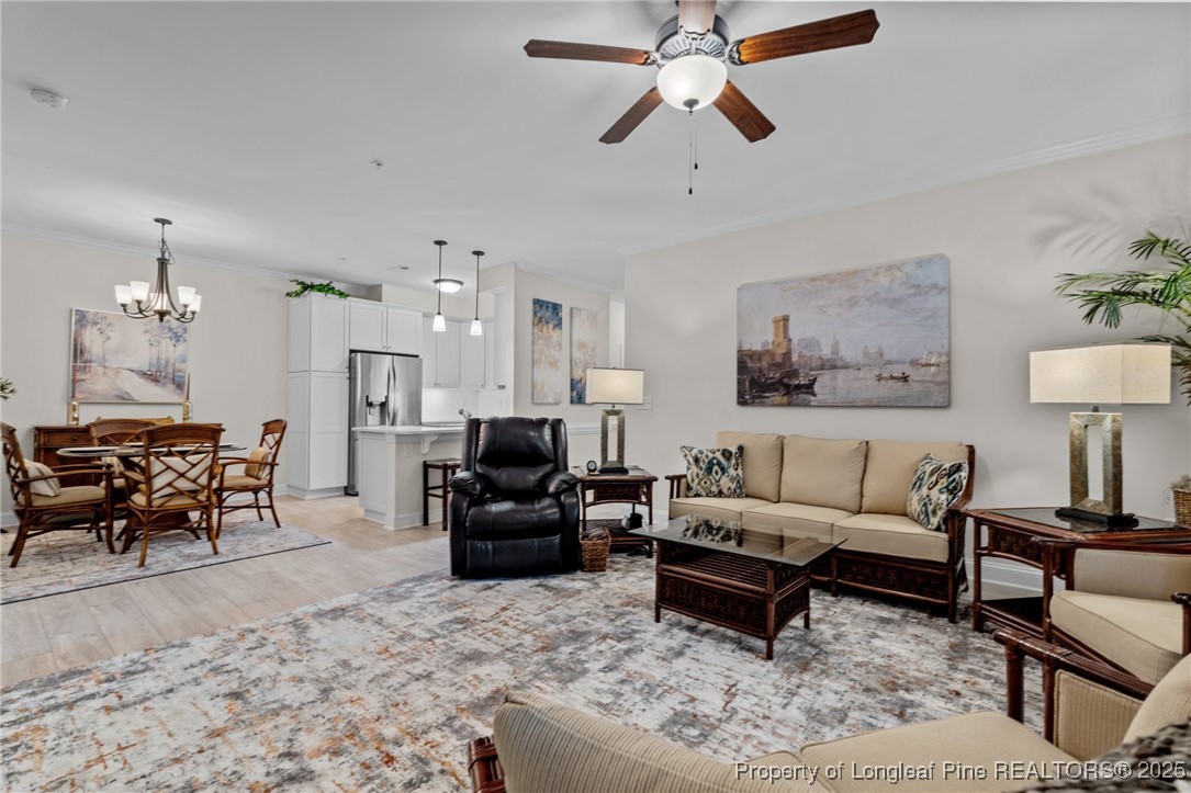 288 Gallery Drive, Unit 204 Spring Lake, NC 28390 - Photo 6 of 27 a living room with furniture a rug and a chandelier