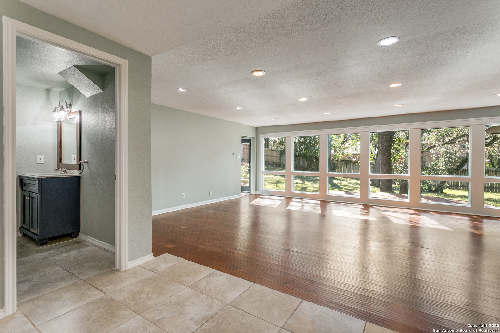 11410 Whisper Moss Street San Antonio, TX 78230 - Photo 15 of 44 a view of empty room with wooden floor and fireplace