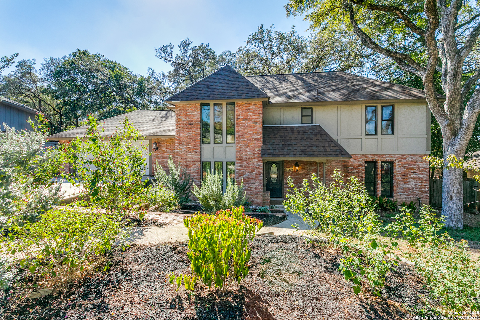 11410 Whisper Moss Street San Antonio, TX 78230 - Photo 2 of 44 a front view of a house with a yard