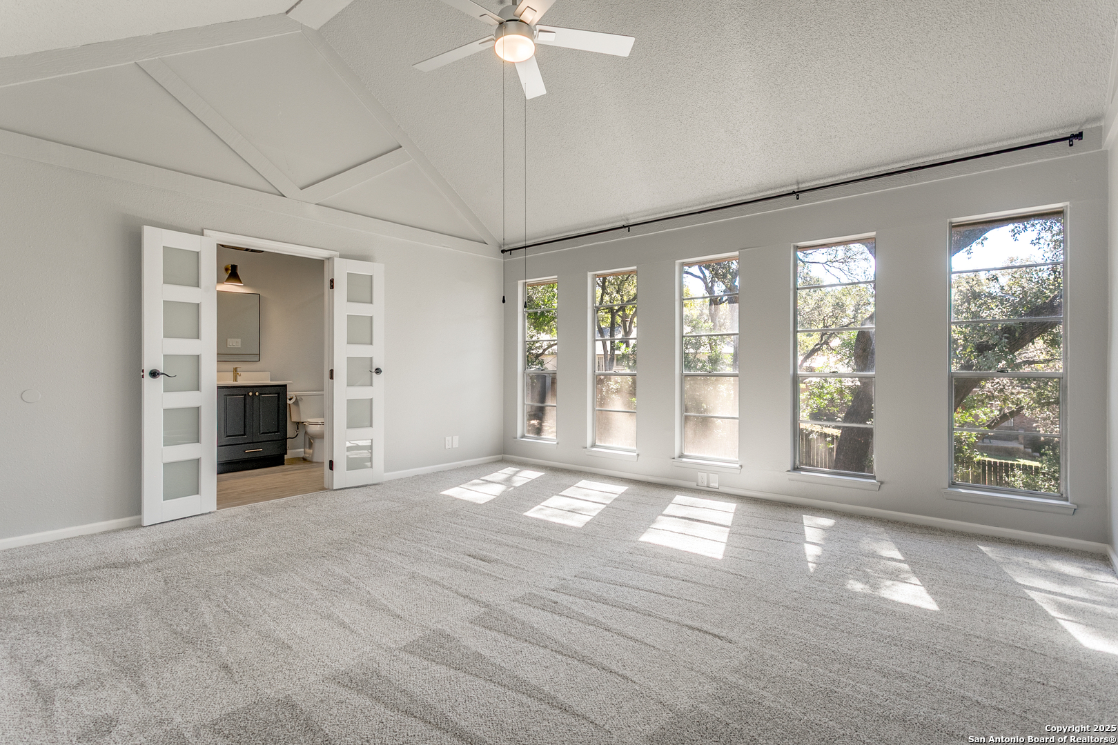 11410 Whisper Moss Street San Antonio, TX 78230 - Photo 25 of 44 a view of an empty room with a window and a kitchen