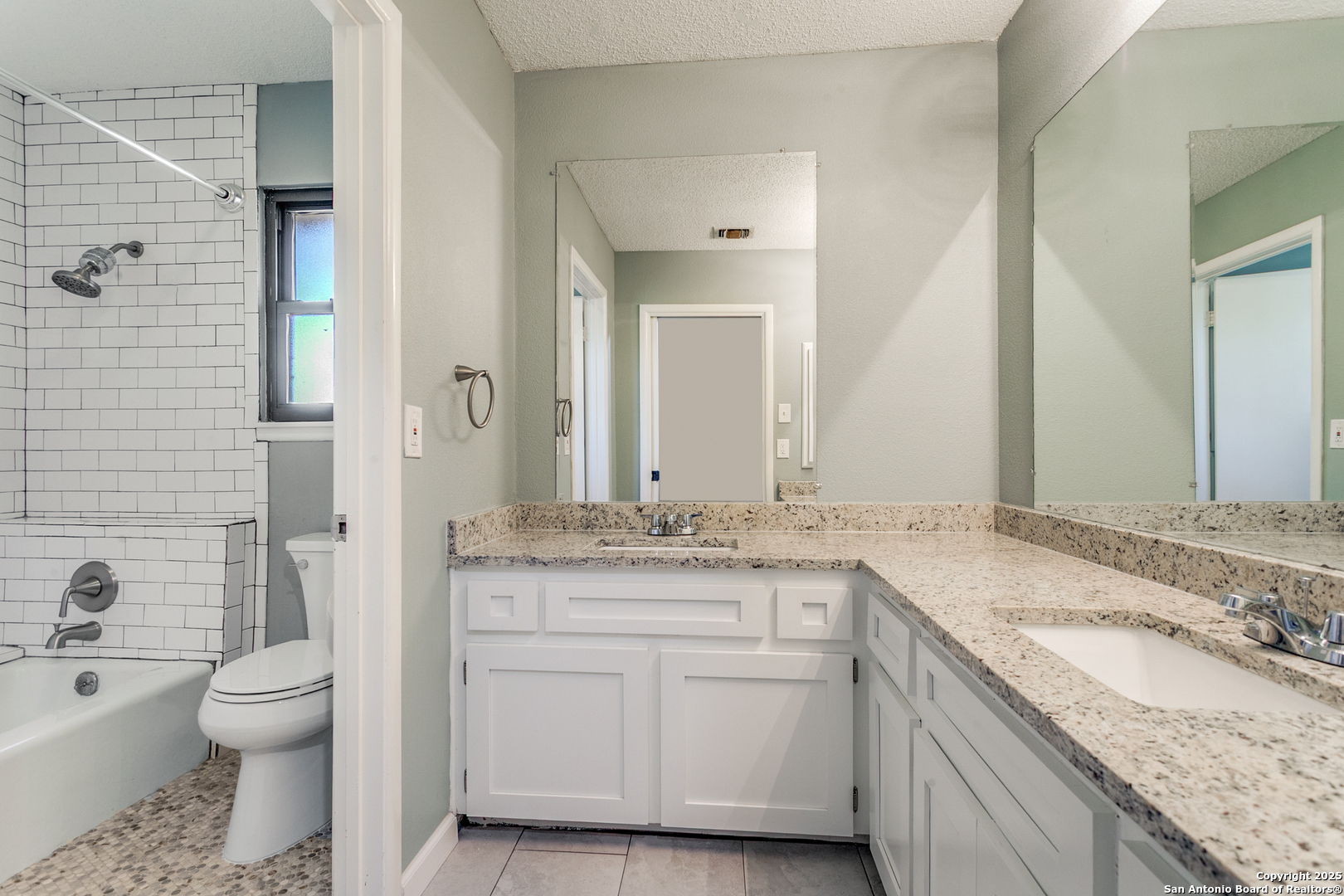 11410 Whisper Moss Street San Antonio, TX 78230 - Photo 28 of 44 a bathroom with a granite countertop sink toilet and shower