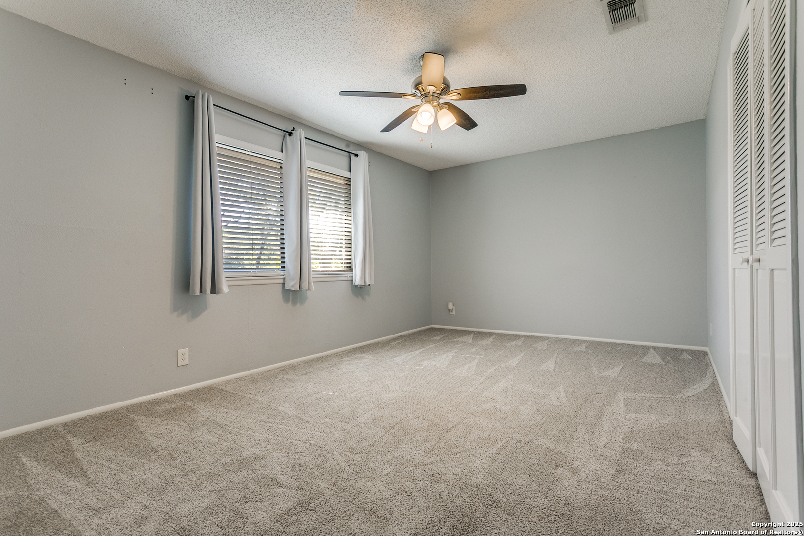 11410 Whisper Moss Street San Antonio, TX 78230 - Photo 29 of 44 an empty room with windows and fan