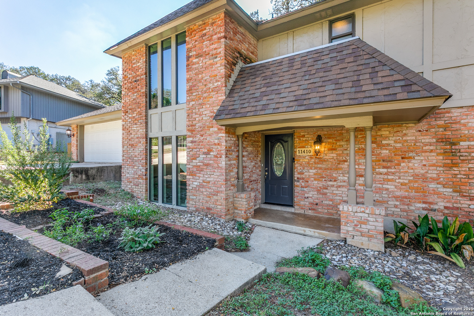 11410 Whisper Moss Street San Antonio, TX 78230 - Photo 4 of 44 a front view of a house with garden