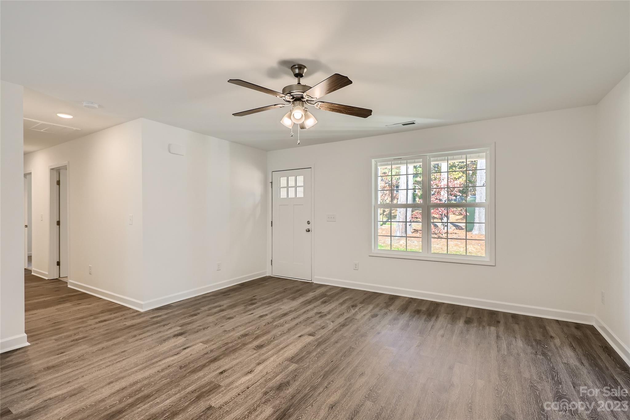 817 North Ransom Street Gastonia, NC 28052 - Photo 2 of 11 a view of an empty room with wooden floor and a window
