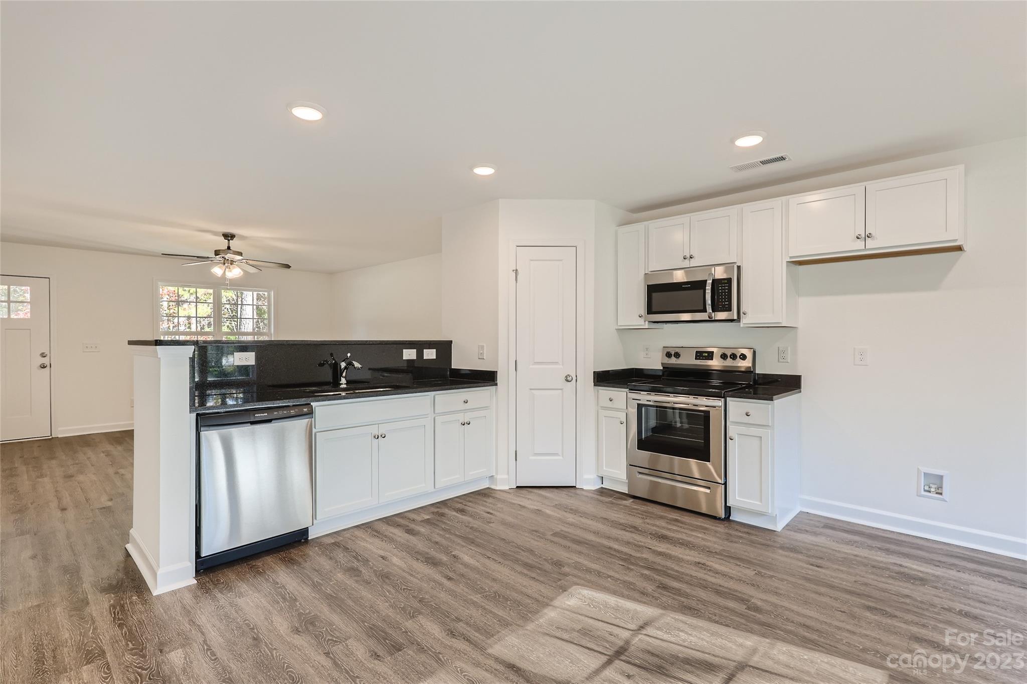 817 North Ransom Street Gastonia, NC 28052 - Photo 3 of 11 a kitchen with granite countertop a sink cabinets and stainless steel appliances