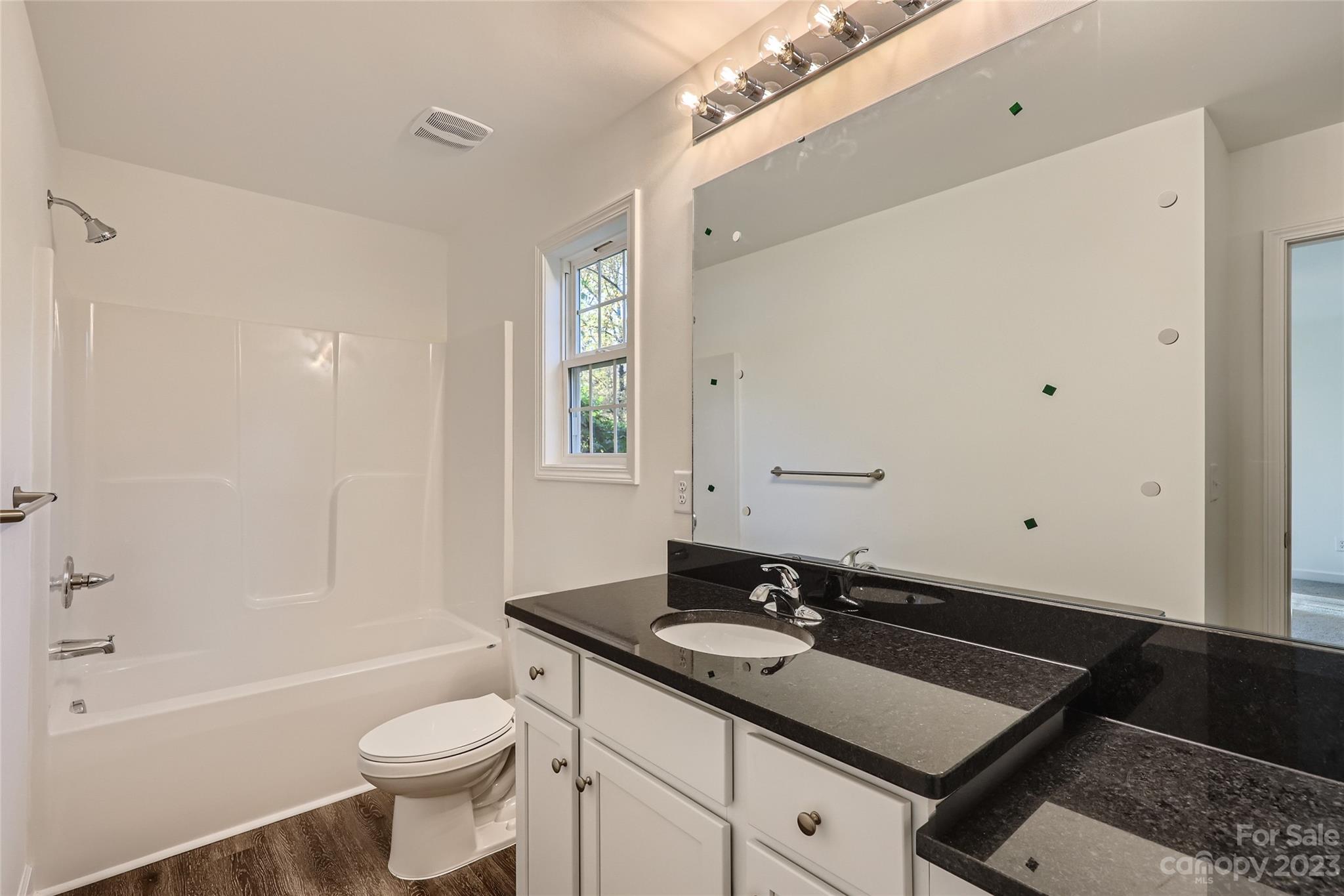 817 North Ransom Street Gastonia, NC 28052 - Photo 5 of 11 a bathroom with a sink and a mirror