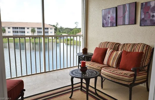 a living room with furniture and a floor to ceiling window