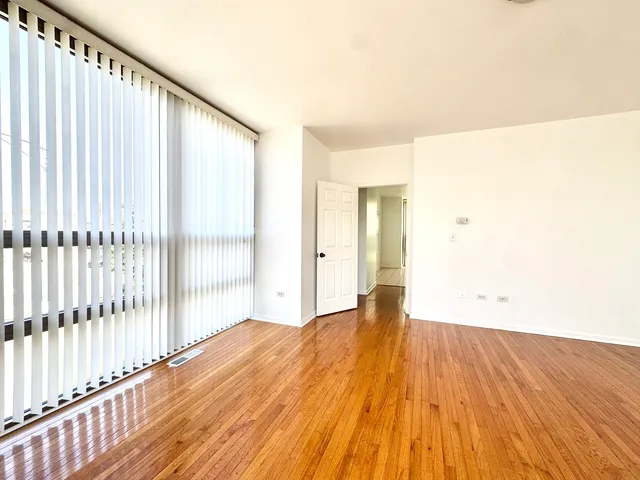 a view of a room with wooden floor