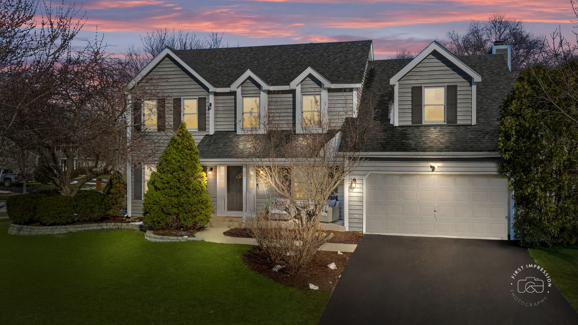 a front view of a house with a yard and garage