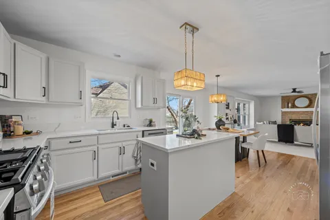 a kitchen with a sink appliances and cabinets